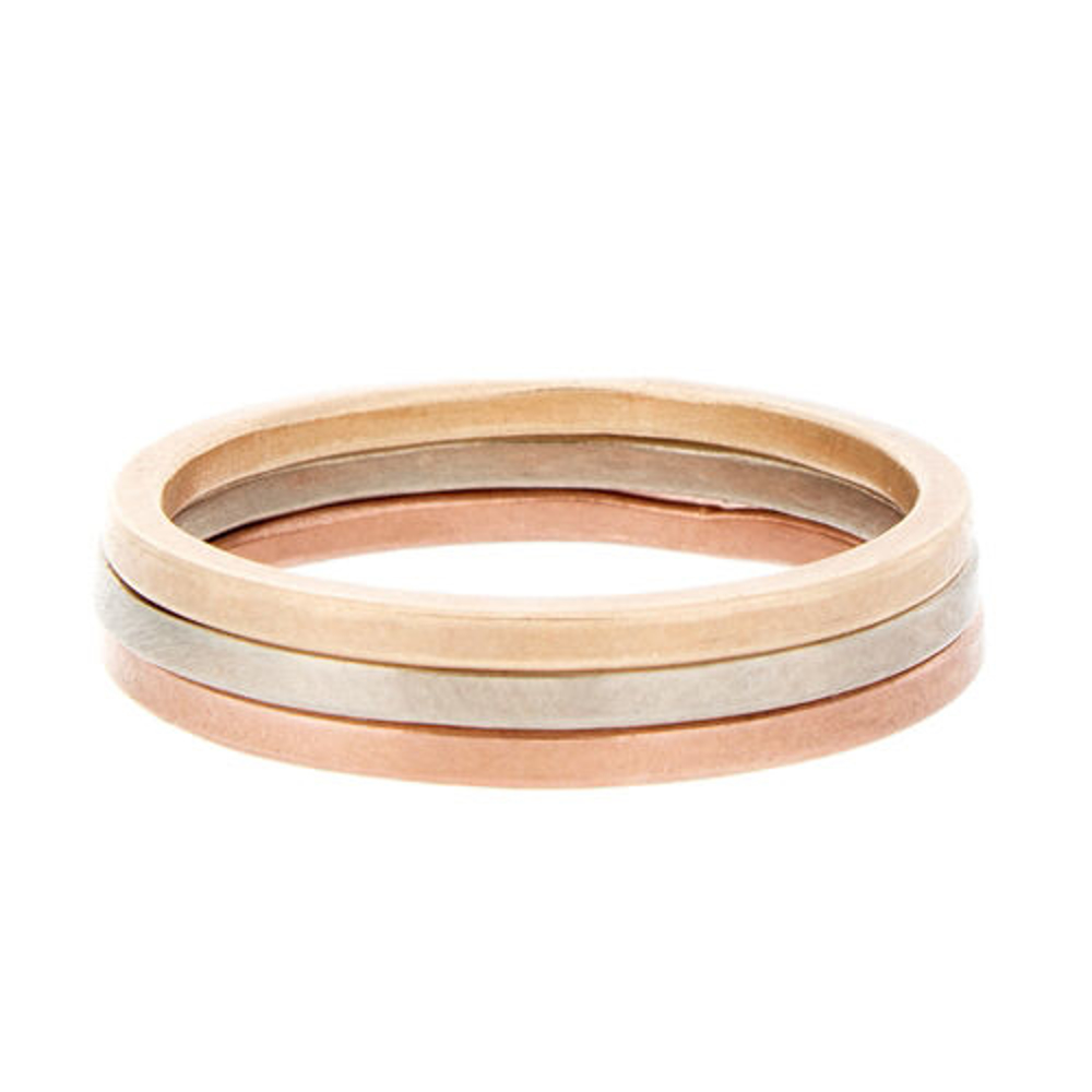 Three dainty 14K gold stacking rings in yellow, white, and pink gold – minimalist jewelry for layering or symbolic stacking